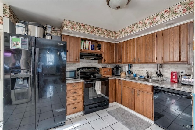 kitchen with sink, decorative backsplash, black appliances, and light tile patterned floors