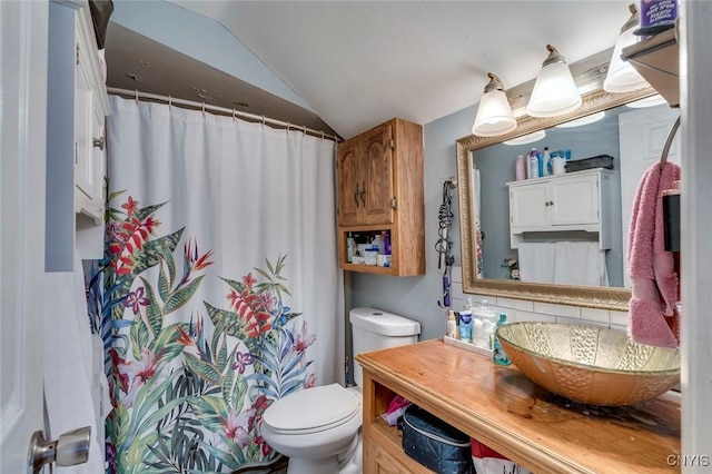 bathroom featuring walk in shower, sink, toilet, and vaulted ceiling