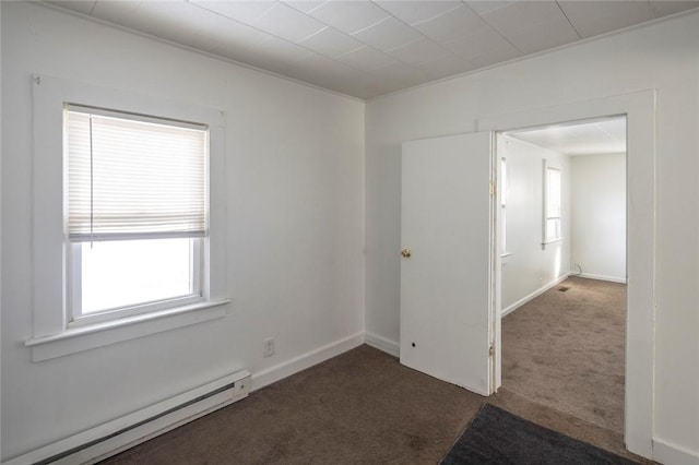 empty room with a baseboard radiator and dark carpet