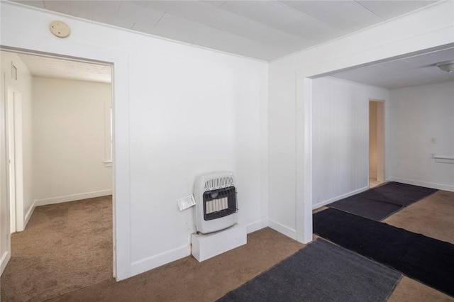 hallway featuring heating unit and carpet flooring