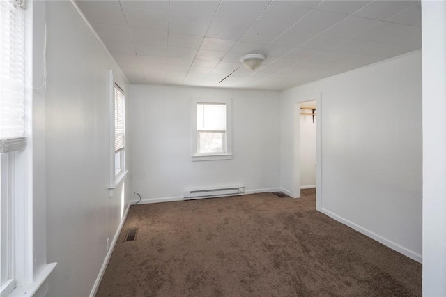 unfurnished room featuring a baseboard heating unit and dark carpet