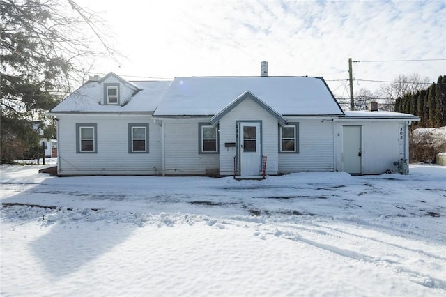 view of snow covered rear of property