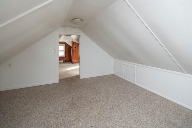 bonus room with vaulted ceiling, baseboard heating, and carpet flooring