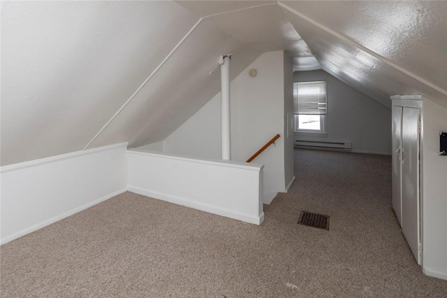 bonus room featuring vaulted ceiling, carpet, and baseboard heating