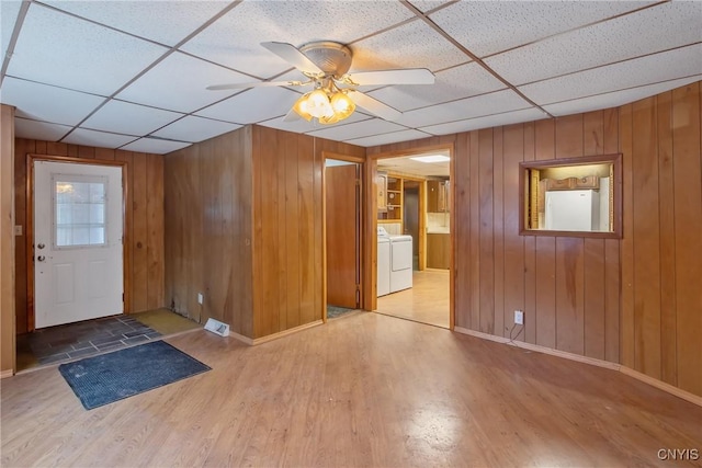 foyer with hardwood / wood-style floors, a paneled ceiling, and washer / clothes dryer