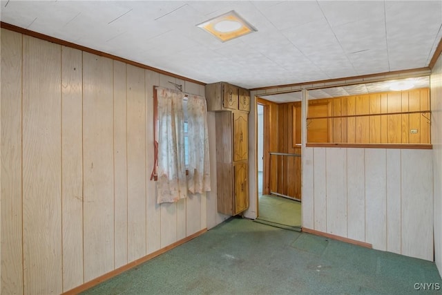 basement featuring carpet flooring and wood walls