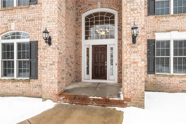 view of snow covered property entrance