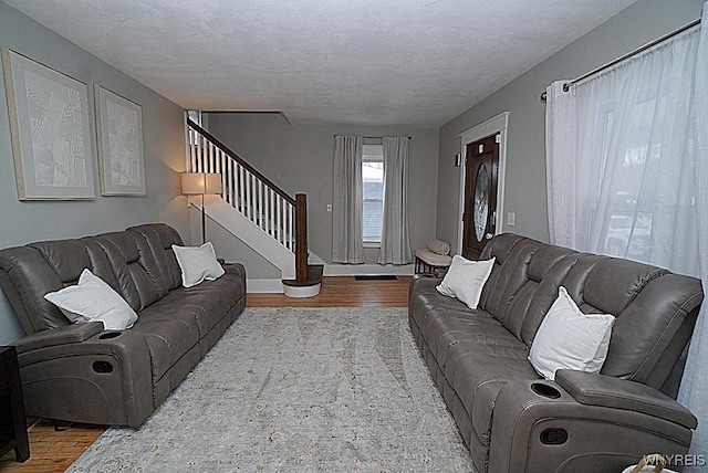 living room featuring hardwood / wood-style flooring and a textured ceiling