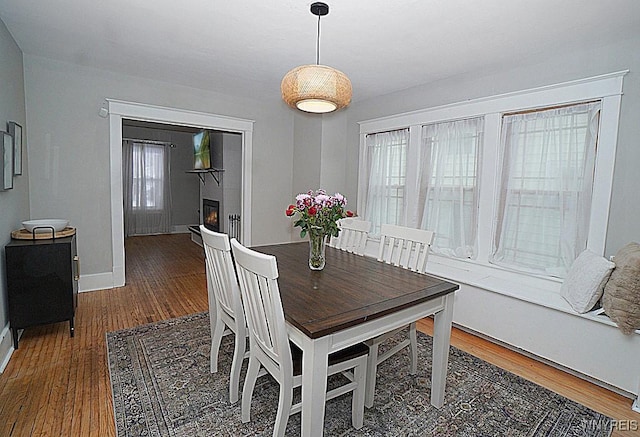 dining space with dark hardwood / wood-style flooring