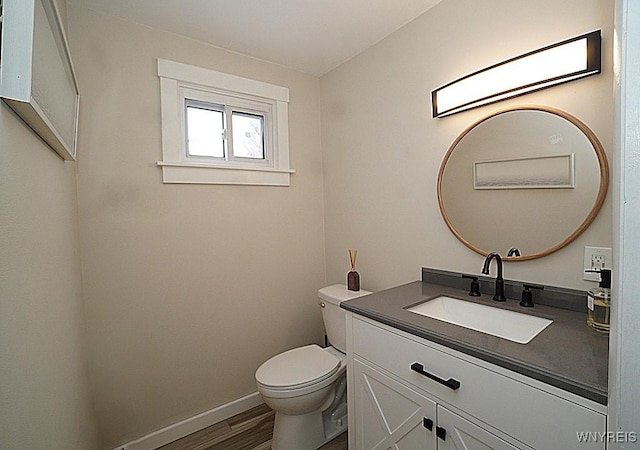 bathroom with vanity, hardwood / wood-style flooring, and toilet