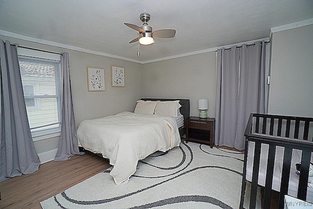 bedroom featuring crown molding, ceiling fan, and light wood-type flooring