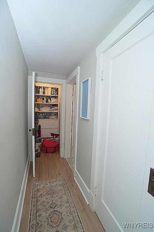 corridor featuring wood-type flooring