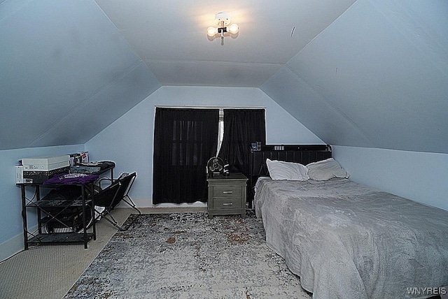 carpeted bedroom featuring lofted ceiling