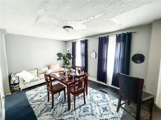 dining room featuring a textured ceiling