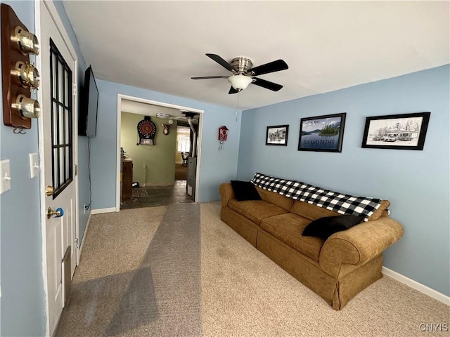 carpeted living room with ceiling fan