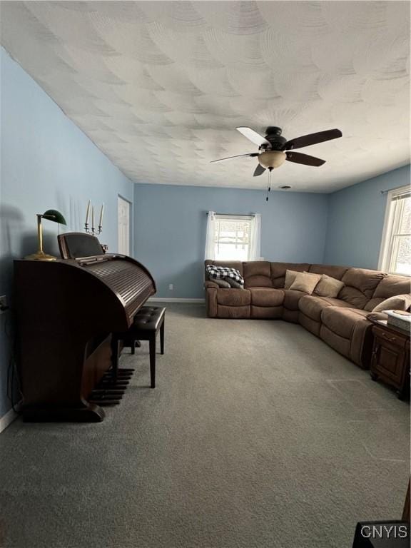 carpeted living room with ceiling fan and a healthy amount of sunlight