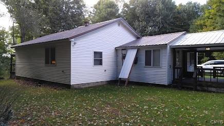 rear view of house with a lawn