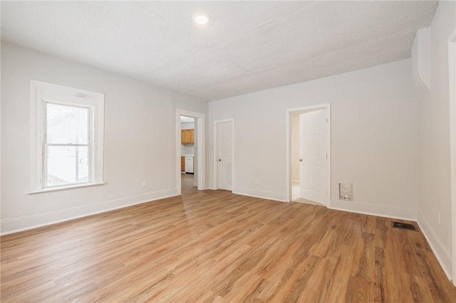 empty room with light hardwood / wood-style flooring