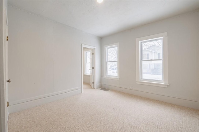 spare room with light colored carpet