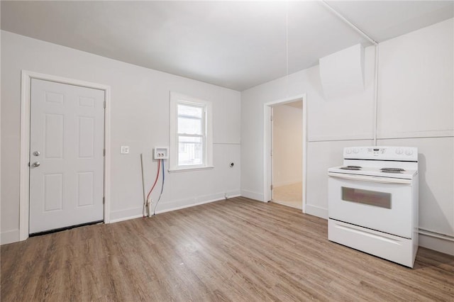 kitchen with electric stove and light hardwood / wood-style floors