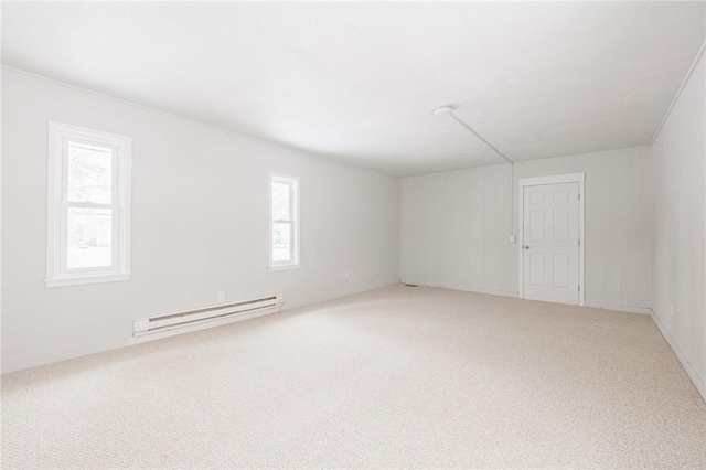 empty room with baseboard heating and carpet flooring