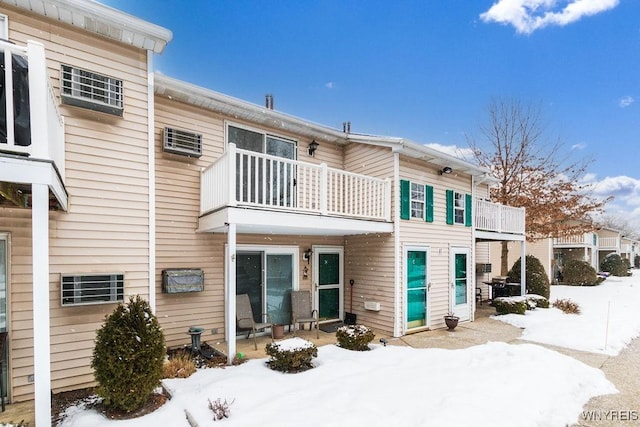 snow covered house with a balcony