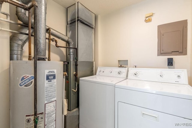 laundry room featuring gas water heater, electric panel, and washing machine and dryer