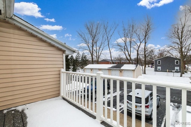 view of snow covered back of property