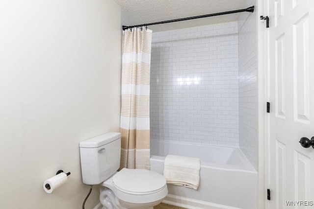 bathroom featuring toilet, a textured ceiling, and shower / bath combo with shower curtain