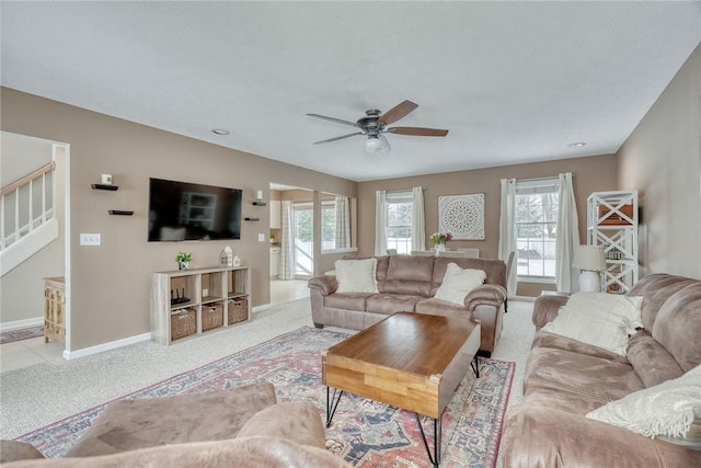 carpeted living room featuring ceiling fan