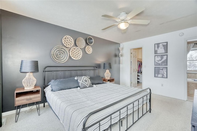 bedroom with a walk in closet, ceiling fan, and a closet