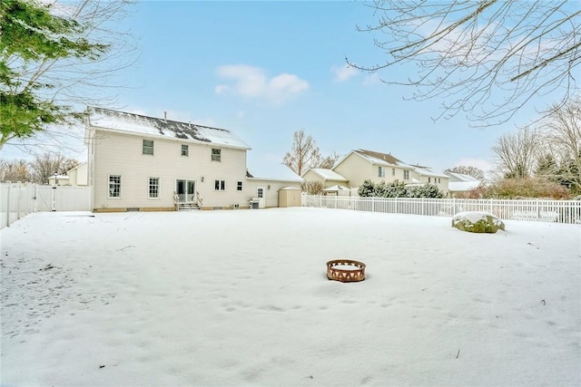 snow covered house with a fire pit