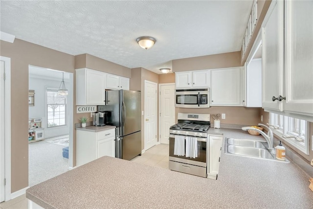 kitchen with white cabinetry, sink, a textured ceiling, and appliances with stainless steel finishes