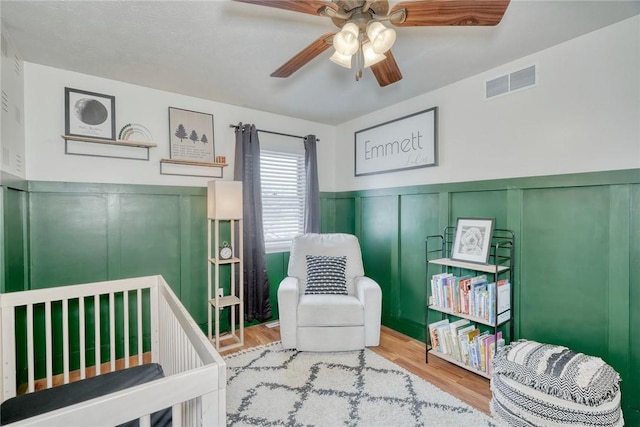 bedroom with wood-type flooring and ceiling fan