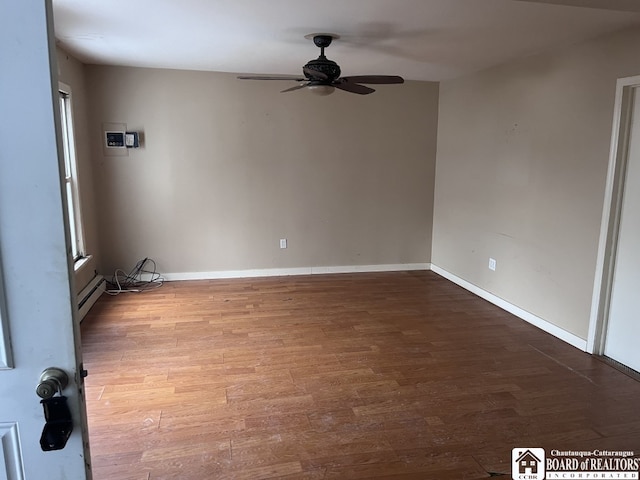 unfurnished room featuring hardwood / wood-style floors, a baseboard radiator, and ceiling fan