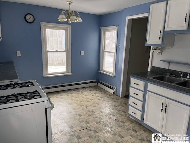 kitchen with white cabinetry, sink, a chandelier, hanging light fixtures, and white gas stove