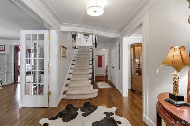 foyer featuring ornamental molding and dark hardwood / wood-style floors