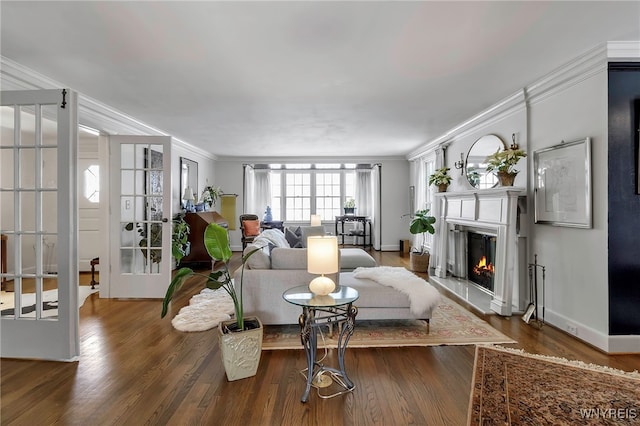 living room with french doors, ornamental molding, and dark hardwood / wood-style floors