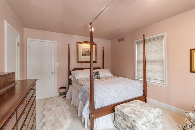 bedroom with light colored carpet