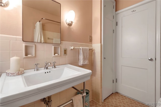 bathroom featuring tile walls and curtained shower