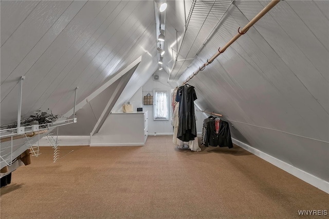 additional living space with carpet flooring and vaulted ceiling