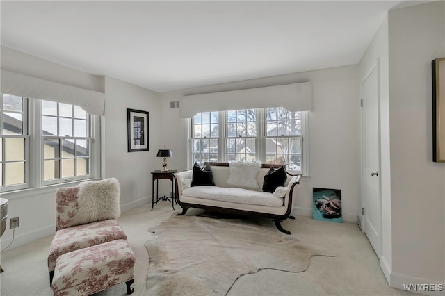 living area with light colored carpet