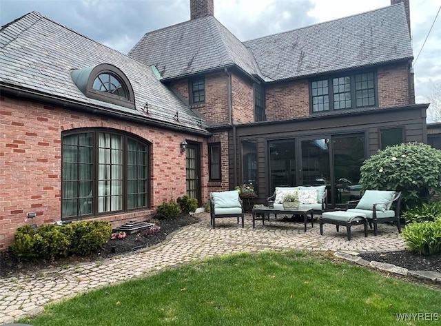 rear view of property featuring an outdoor living space, a yard, and a patio area