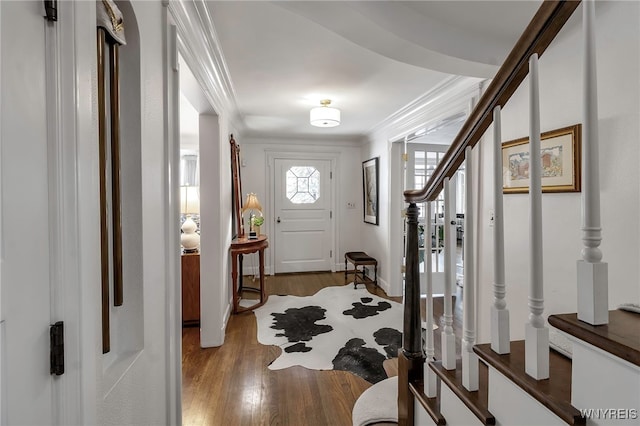 foyer entrance with crown molding and light hardwood / wood-style flooring