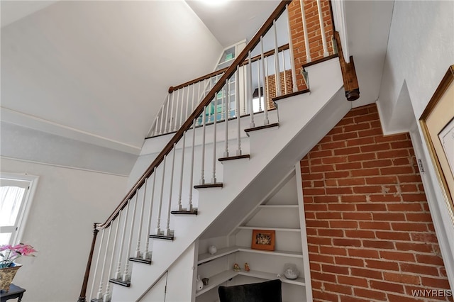 stairway with built in features and a high ceiling