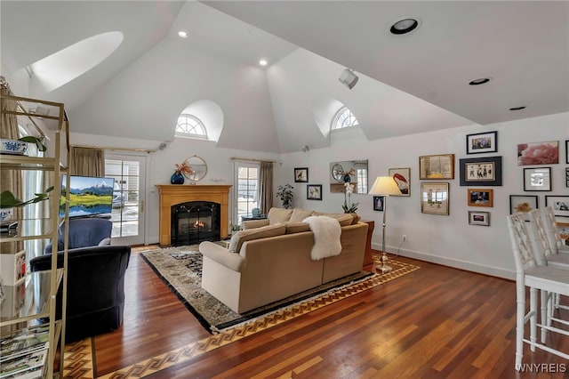 living room featuring dark hardwood / wood-style floors and high vaulted ceiling