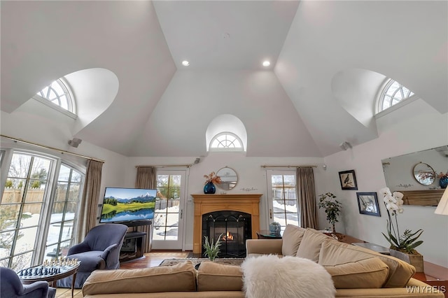 living room featuring plenty of natural light and high vaulted ceiling