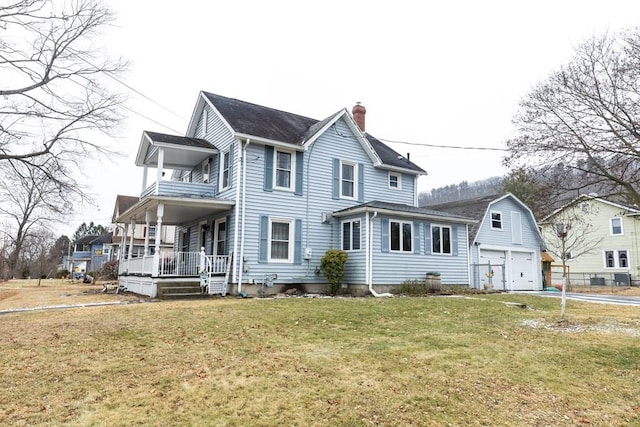 view of front facade with a garage, a front lawn, a balcony, and covered porch