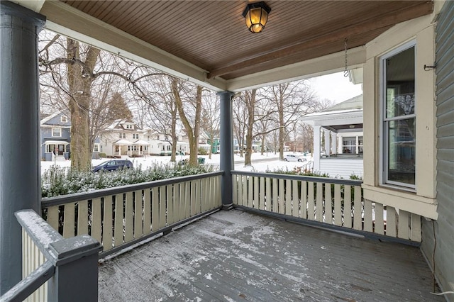 snow covered deck with covered porch