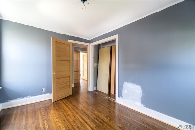 unfurnished bedroom with dark hardwood / wood-style floors